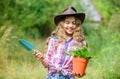 Planting plants. Happy childhood. Child in hat with shoulder blade small shovel hoe. Happy smiling gardener girl. Ranch Royalty Free Stock Photo