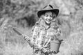 Planting plants. Happy childhood. Child in hat with shoulder blade small shovel hoe. Happy smiling gardener girl. Ranch Royalty Free Stock Photo