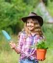 Planting plants. Happy smiling gardener girl. Ranch girl. Little kid hold flower pot. Spring country works. Happy Royalty Free Stock Photo