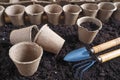 Background with peat pots and the ground. Spring planting work. Royalty Free Stock Photo