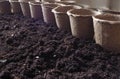 Background with peat pots and the ground. Spring planting work. Royalty Free Stock Photo