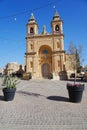 Plants in front of parish church of our lady of pompei in Marsaxlokk, Malta - vertical Royalty Free Stock Photo