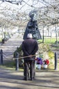 An old man prays before the sculpture of the Virgen del Puerto located in the Coronation Park