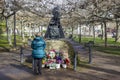 An old woman prays before the sculpture of the Virgen del Puerto located in the Coronation Park