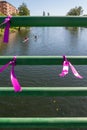 Three purple bracelets tied to a bridge in memory of the victims of gender based violence due to machismo