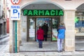 PLASENCIA, SPAIN - DECEMBER 07, 2020: Queue of people waiting to access the interior of the pharmacy