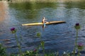 A young woman practices canoeing riding in his canoe navigating the Jerte river