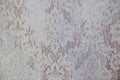 Plaster background floral pattern.Vintage white floral pattern, wallpaper.Seamless wallpaper.Loft styled wall. Royalty Free Stock Photo