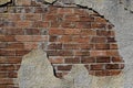 Plaster crumbling exposing bricks