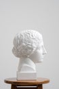 Plaster head, antique sculpture for learning to draw. Standing on a stool on a white background. Royalty Free Stock Photo