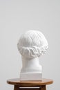 Plaster head, antique sculpture for learning to draw. Standing on a stool on a white background. Royalty Free Stock Photo