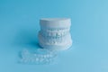 Plaster human jaw model and essix retainer for dental correction.