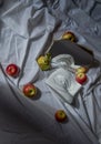 Plaster marble copy eye of david reflected in a mirror in gold frame on white drapery fabric with folds with apples and pears Royalty Free Stock Photo