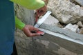 plaster worker use stainless steel ruler measure lightweight cement window brick prepare for install