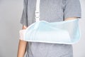 Plastered arm, broken arms at teenagers on a white background