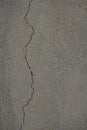 Plastered concrete wall with long vertical crack. Cracked cement wall. Broken wall background Royalty Free Stock Photo