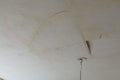 A plastered house ceiling broken by a water leak. rain or tap water caused serious damage