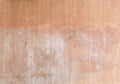 Plastered, painted and faded peachy wall background