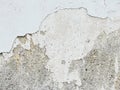 Background, surface texture. a layer of white peeling paint on rough gray concrete, cement, plastered wall. Royalty Free Stock Photo