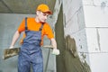 Plasterer applying plaster on block wall. Rennovation Royalty Free Stock Photo