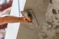 Plasterer concrete on wall of house construction