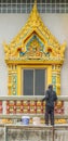 plasterer concrete worker at balcony of temple construction.