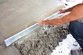 Plasterer concrete worker at floor work Royalty Free Stock Photo