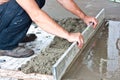 Plasterer concrete worker at floor work Royalty Free Stock Photo