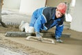 Plasterer concrete worker at floor work