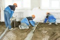 Plasterer concrete worker at floor work