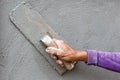 Plasterer concrete worker at wall of house construction