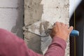 Plasterer concrete worker at wall of house construction