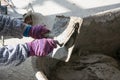 Plasterer concrete worker at wall of house construction