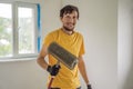 plasterer during floor covering works with self-levelling cement mortar, uses a needle roller