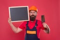 Plasterer hipster builder in hard hat hold blackboard copy space. Professional plasterer. Dreams come true. Skillful