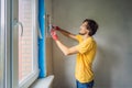 Plasterer home improvement handyman worker with putty knife working on apartment wall filling Royalty Free Stock Photo