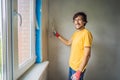 Plasterer home improvement handyman worker with putty knife working on apartment wall filling Royalty Free Stock Photo