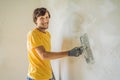 Plasterer home improvement handyman worker with putty knife working on apartment wall filling Royalty Free Stock Photo