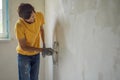 Plasterer home improvement handyman worker with putty knife working on apartment wall filling Royalty Free Stock Photo