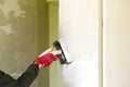 Plasterer home improvement handyman worker with putty knife working on apartment wall filling. Home renovation concept Royalty Free Stock Photo