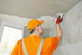 Plasterer at indoor ceiling work