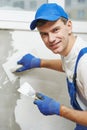 Plasterer at indoor wall work