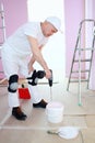 Plasterer knead the solution with a Royalty Free Stock Photo