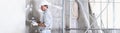 Plasterer man at work with trowel plastering the wall of interior construction site wear helmet and protective gloves, white wall Royalty Free Stock Photo