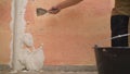 Plasterer putting plaster on wall. Putting plaster on the wall. Stucco between the holes Royalty Free Stock Photo
