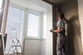 Plasterer renovating indoor walls and ceilings. Construction finishing works.