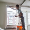 Plasterer renovating indoor walls and ceilings.