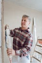 Plasterer smoothing interior wall with machine Royalty Free Stock Photo