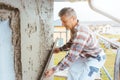 Plasterer smoothing plaster on a facade