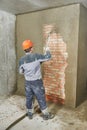 Plasterer spraying plaster on wall Royalty Free Stock Photo